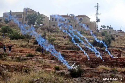 Tear gas canisters are seen after they were fired by Israeli security forces during clashes with Palestinian protesters next to the Israeli Ofer prison, following a demonstration against the building of Israeli settlemen...