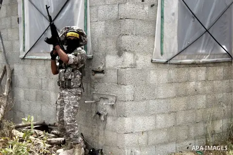 A masked Palestinian militant of al-Aqsa Martyrs' Brigades, a group linked to the Fatah movement, demonstrates his skills during a training in in central Gaza Strip on May 24, 2015. Photo by Nidal Alwaheidi
