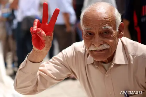 Palestinians lay hands imprint as they take part in a rally marking the 67th anniversary of the "Nakba, in the West Bank city of Ramallah, on May 26, 2015. Photo by Shadi Hatem