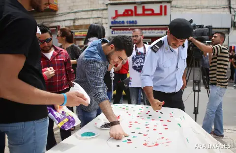 Palestinians lay hands imprint as they take part in a rally marking the 67th anniversary of the "Nakba, in the West Bank city of Ramallah, on May 26, 2015. Photo by Shadi Hatem