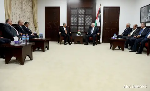Palestinian President, Mahmoud Abbas (Abu Mazen) meets with heads of delegations participating in the International Conference on Public Administration states in the West Bank city of Ramallah on May 26, 2015. Photo by O...