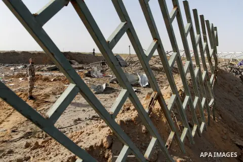 A Palestinian security man looks at a crater on the ground following an Israeli airstrike in the southern Gaza Strip near the town, of Rafah on May 27,2015. The Israeli air force carried out four strikes on militant targ...
