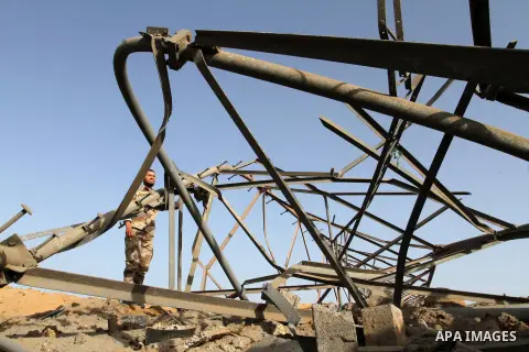 A Palestinian security man looks at a crater on the ground following an Israeli airstrike in the southern Gaza Strip near the town, of Rafah on May 27,2015. The Israeli air force carried out four strikes on militant targ...