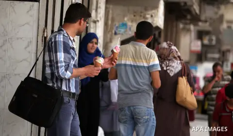 Palestinians buy ice-cream during hot weather in Gaza city on May 27, 2015. Hot weather hit Gaza Strip on Wednesday, and the temperature reached more than 39 degrees Celsius (102 degree Fahrenheit) at noon, Gazans escape...