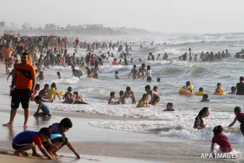 Palestinians enjoy a day at the beach of the Mediterranean Sea on the coast of Gaza City, on May 29, 2015. Photo by Mohammed Asad
