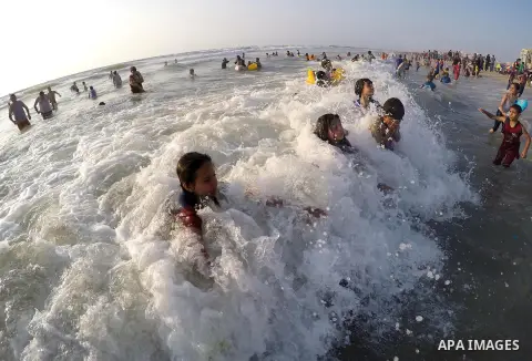 Palestinians enjoy a day at the beach of the Mediterranean Sea on the coast of Gaza City, on May 29, 2015. Photo by Mohammed Asad