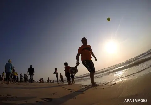 Palestinians enjoy a day at the beach of the Mediterranean Sea on the coast of Gaza City, on May 29, 2015. Photo by Mohammed Asad