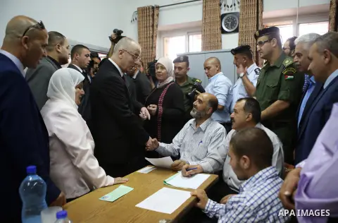 Palestinian Prime Minister Rami Hamdallah visits a school during the first day of high school exams, known as "Tawjihi", in the West Bank city of Ramallah, on May 30, 2015. Nearly 81,000 Palestinian students sat for the...