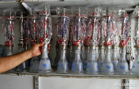 A Palestinian vendor displays hookah supplies at his shop in the southern Gaza Strip City of Rafah, on May 23, 2015. Smuggling through tunnels began several months after Islamic Hamas movement's control of the Gaza Strip...