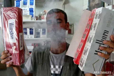A Palestinian vendor sells cigarettes in the southern Gaza Strip City of Rafah, on May 31, 2015. Smuggling through tunnels began several months after Islamic Hamas movement's control of the Gaza Strip and the Israeli blo...
