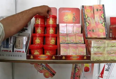 A Palestinian vendor displays hookah tobacco at his shop in the southern Gaza Strip City of Rafah, on May 23, 2015. Smuggling through tunnels began several months after Islamic Hamas movement's control of the Gaza Strip...