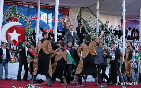 Palestinian grooms celebrate during a mass wedding ceremony in Gaza City, on May 31, 2015. Nearly 2000 Palestinian couples were married in a ceremony funded by the Turkish government and supported by the Hamas movement....