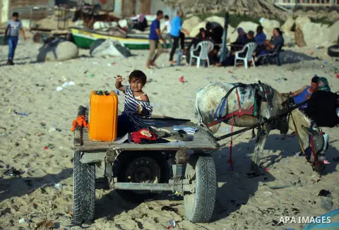 Palestinians enjoy a summer day at the beach in Gaza city, on June 5, 2015. Friday is the Muslim holiday and as summer is entering many Palestinian people go to the beach since it is the major entertainment area in the G...
