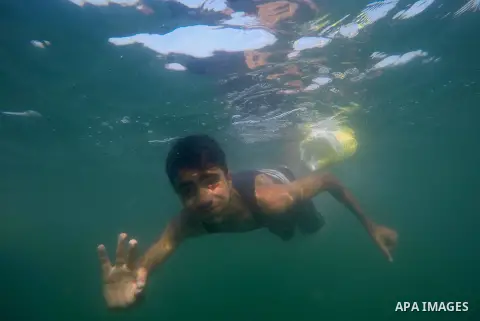 Palestinian boys take part in a training camps of the swimming organized by the Hamas movement into the Mediterranean Sea in Gaza City, on June 6, 2015. Photo by Mohammed Asad