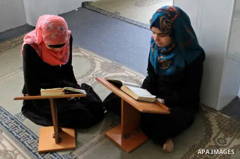 Palestinian girls attend a Quran lesson at a Hamas-sponsored summer program, during summer vacation at a mosque in Rafah, southern Gaza Strip, on June 7, 2015. The Quran memorisation program is one of the latest activiti...