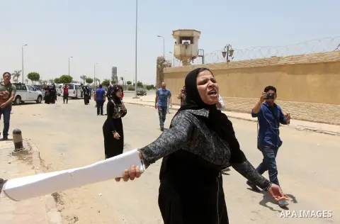 Egyptian families of the victims of a February 2012 riot in the eastern city of Port Said gather outside a court in Cairo on June 9, 2015 as they wait for the final verdict in the retrial of football fans over the riot t...