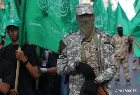 Palestinian youths march during a graduation ceremony of a military-style camp organized by the Hamas movement in Gaza City on January 29, 2015. Tens of thousands of children from the Gaza Strip spend at least part of th...