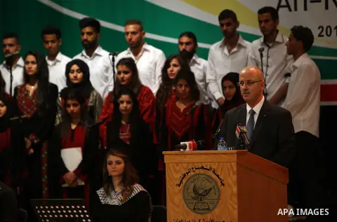 Palestinian Prime Minister Rami Hamdallah attends a graduation ceremony at al-Najah University, in the West Bank city of Nablus, on June 10, 2015. Photo by Prime Minister Office