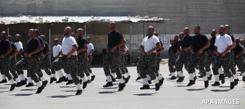 Members of Palestinian national security forces demonstrate their skills during a military graduation ceremony in the northern Gaza Strip, June 11, 2015. Photo by Ashraf Amra