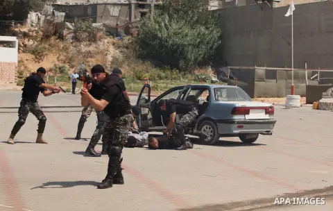 Members of Palestinian national security forces demonstrate their skills during a military graduation ceremony in the northern Gaza Strip, June 11, 2015. Photo by Ashraf Amra
