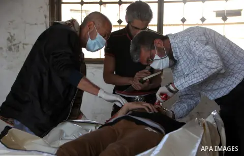 Syrian medics inspect the body of an unidentified killed man found in Saliheen neighborhood, at a hospital morgue in al-Sukari district in the east of the northern Syrian city of Aleppo on June 11, 2015. Photo by Ameer a...