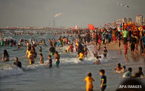 Palestinians enjoy a day at the beach of the Mediterranean Sea on the coast of Gaza City, on June 12, 2015. Photo by Ashraf Amra
