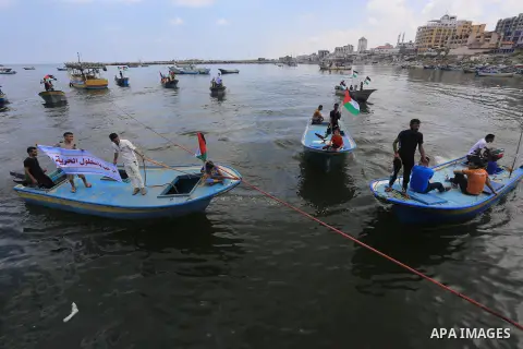 Palestinian children hold flags and banners during a rally to show solidarity with Third Freedom Flotilla in Gaza port on June 14, 2015. The flotilla is the third of its kind since 2010, when the first Freedom Flotilla w...