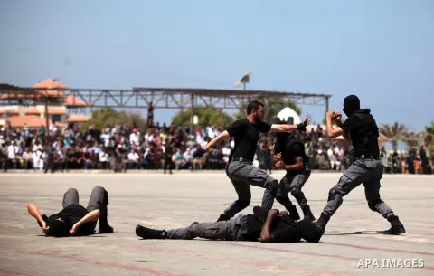 Members of the Palestinian Hamas security forces demonstrate their skills as they take part in a graduation ceremony in Gaza City on June 16, 2015. Photo by Ashraf Amra