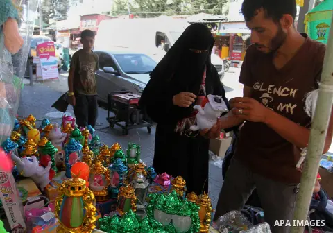 A Palestinian vendor displays traditional lanterns known in Arabic as "Fanous" sold during the Muslim holy month of Ramadan at a market in Rafah in the southern Gaza strip, on June 17, 2015 as the faithful prepare to sta...