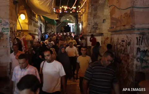 Palestinian Muslim worshipers walk outside the al-Al-Aqsa mosque following the first 'taraweeh', nightly prayer of the month of Ramadan, in Jerusalem's old city on June 17, 2015. Millions of Muslims around the world will...