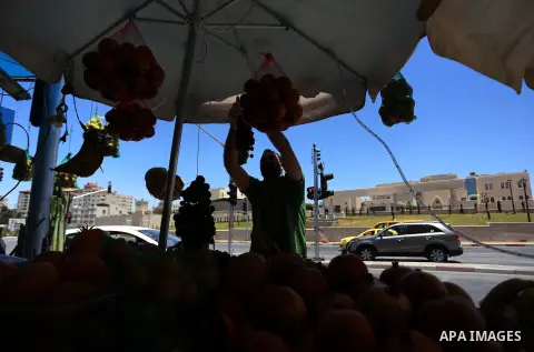 A Palestinian vendor sells fruits at a market on the first day of the holy month of Ramadan in the West Bank city of Ramallah June 18, 2015.as the faithful prepare to start fasting. More than 1.5 billion Muslims around t...
