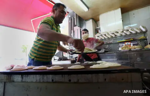 A Palestinian vendor prepares traditional pancakes known as ''Qatayef'' on the first day of the holy month of Ramadan in the West Bank city of Ramallah June 18, 2015.as the faithful prepare to start fasting. More than 1....