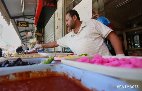 A Palestinian vendor sells pickles at a market on the first day of the holy month of Ramadan in the West Bank city of Ramallah June 18, 2015.as the faithful prepare to start fasting. More than 1.5 billion Muslims around...