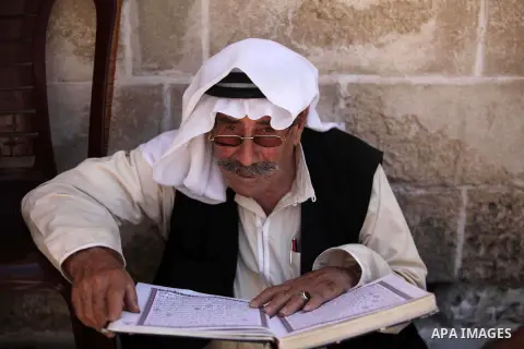 A Palestinian man reads the Koran in a mosque during the holy month of Ramadan in Gaza city on 18 June 2015. Muslims around the world are observing the holy fasting month of Ramadan in which they refrain from eating, dri...