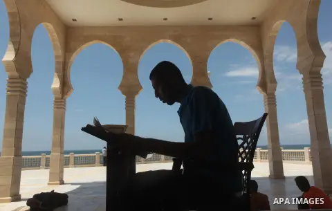 A Palestinian man reads the Koran in a mosque during the holy month of Ramadan in Gaza city on 20 June 2015. Muslims around the world are observing the holy fasting month of Ramadan in which they refrain from eating, dri...