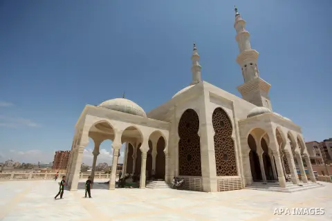 Palestinian man walk outside a mosque during the holy month of Ramadan in Gaza city on 20 June 2015. Muslims around the world are observing the holy fasting month of Ramadan in which they refrain from eating, drinking, s...