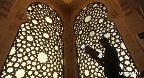 A Palestinian man reads the Koran in a mosque during the holy month of Ramadan in Gaza city on 20 June 2015. Muslims around the world are observing the holy fasting month of Ramadan in which they refrain from eating, dri...