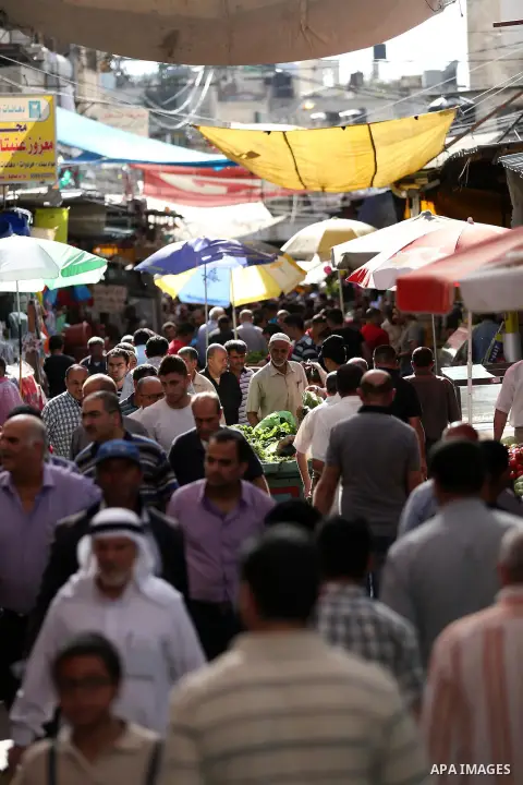 Palestinians walk in a street market on the holy month of Ramadan, in the West Bank city of Nablus on June 20, 2015. During Ramadan, Muslim believers abstain from eating, drinking, smoking and having sex from dawn until...