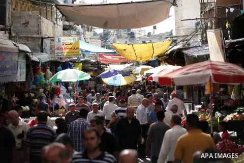 Palestinians walk in a street market on the holy month of Ramadan, in the West Bank city of Nablus on June 20, 2015. During Ramadan, Muslim believers abstain from eating, drinking, smoking and having sex from dawn until...