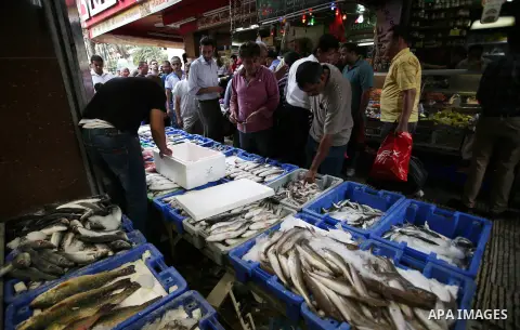 A Palestinian vendor sells fishes in a street market on the holy month of Ramadan, in the West Bank city of Nablus on June 20, 2015. During Ramadan, Muslim believers abstain from eating, drinking, smoking and having sex...