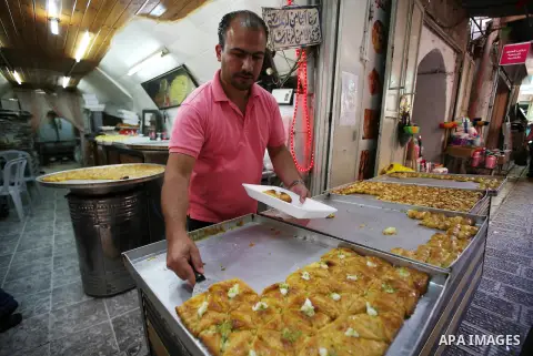 A Palestinian vendor sells sweets in a street market on the holy month of Ramadan, in the West Bank city of Nablus on June 20, 2015. During Ramadan, Muslim believers abstain from eating, drinking, smoking and having sex...