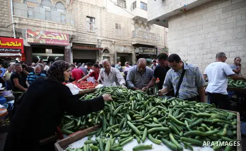 A Palestinian vendor sells vegetables in a street market on the holy month of Ramadan, in the West Bank city of Nablus on June 20, 2015. During Ramadan, Muslim believers abstain from eating, drinking, smoking and having...