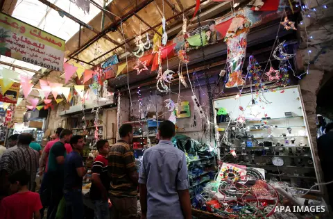 Palestinians walk in a street market on the holy month of Ramadan, in the West Bank city of Nablus on June 20, 2015. During Ramadan, Muslim believers abstain from eating, drinking, smoking and having sex from dawn until...