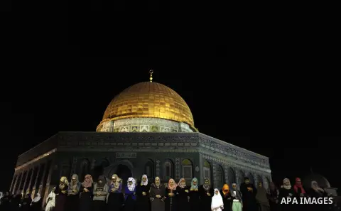 Palestinian Muslim worshipers perform 'taraweeh', nightly prayer of the month of Ramadan outside the al-Aqsa mosque in Jerusalem's old city on June 20, 2015. During Ramadan, Muslim believers abstain from eating, drinking...