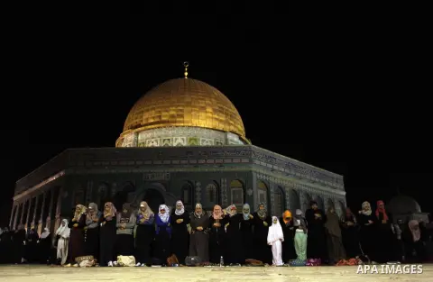 Palestinian Muslim worshipers perform 'taraweeh', nightly prayer of the month of Ramadan outside the al-Aqsa mosque in Jerusalem's old city on June 20, 2015. During Ramadan, Muslim believers abstain from eating, drinking...