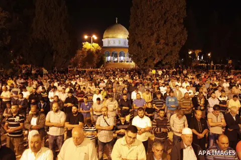 Palestinian Muslim worshipers perform 'taraweeh', nightly prayer of the month of Ramadan outside the al-Aqsa mosque in Jerusalem's old city on June 20, 2015. During Ramadan, Muslim believers abstain from eating, drinking...