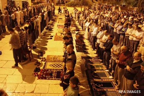 Palestinian Muslim worshipers perform 'taraweeh', nightly prayer of the month of Ramadan outside the al-Aqsa mosque in Jerusalem's old city on June 20, 2015. During Ramadan, Muslim believers abstain from eating, drinking...
