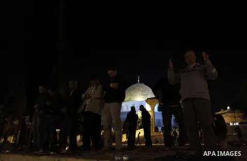 Palestinian Muslim worshipers perform 'taraweeh', nightly prayer of the month of Ramadan outside the al-Aqsa mosque in Jerusalem's old city on June 20, 2015. During Ramadan, Muslim believers abstain from eating, drinking...