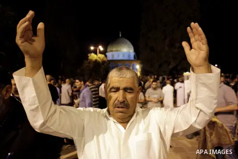 Palestinian Muslim worshipers perform 'taraweeh', nightly prayer of the month of Ramadan outside the al-Aqsa mosque in Jerusalem's old city on June 20, 2015. During Ramadan, Muslim believers abstain from eating, drinking...