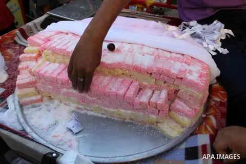 A Palestinian man sells sweets in a street market on the holy month of Ramadan, in Rafah in the southern Gaza Strip on June 22, 2015. During Ramadan, Muslim believers abstain from eating, drinking, smoking and having sex...